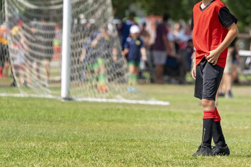 Cropped image of a schoolboy playing football