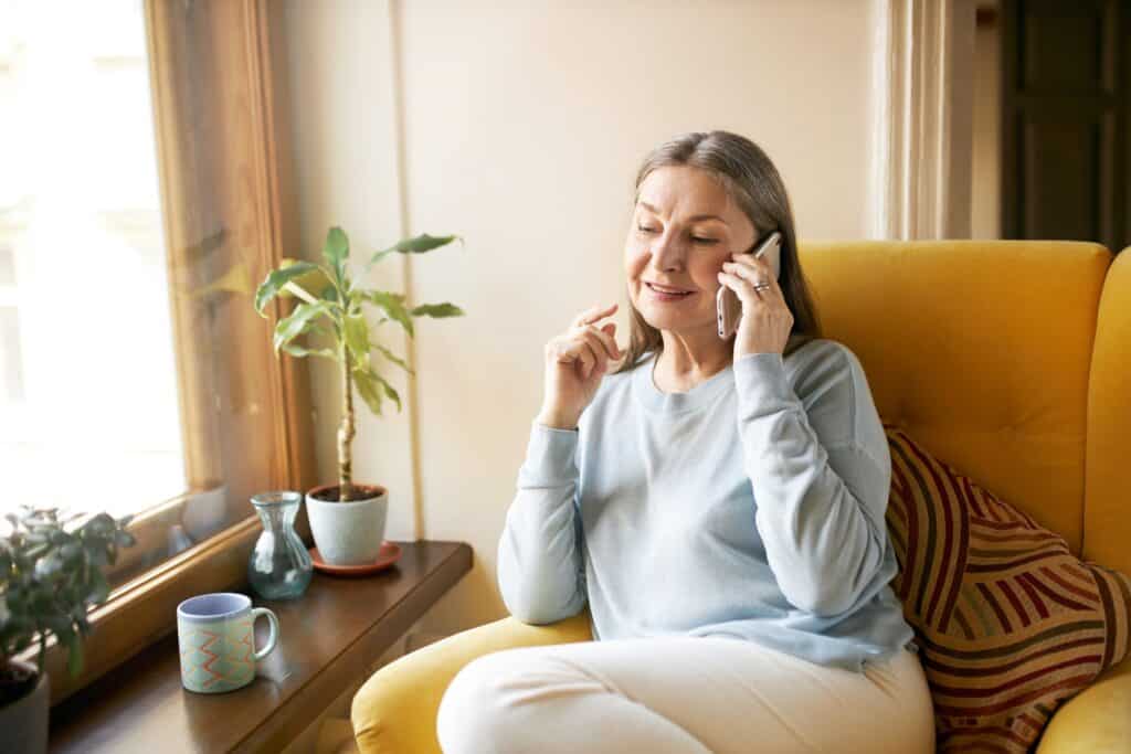 A senior female speaking with a Man and Van on the phone